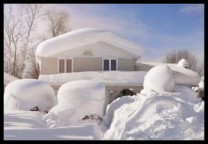 House buried in snow with border