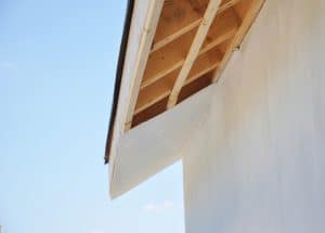 Installig eaves, soffit boards, fascias on new house roofing construction